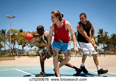 Male basketball team practicing on basketball court View Large Photo Image Stock Photograph - Male basketball team practicing on basketball court. Fotosearch