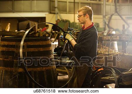 Male cooper making whisky casks in cooperage View Large Photo Image Stock Photo - Male cooper making whisky casks in cooperage. Fotosearch