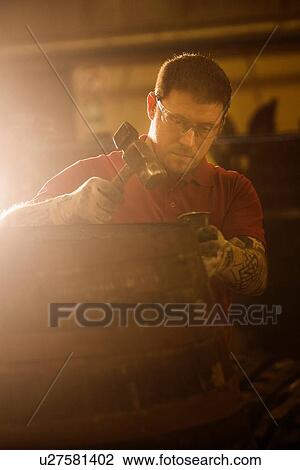Male cooper using hammer in cooperage with whisky cask View Large Photo Image Stock Image - Male cooper using hammer in cooperage with whisky cask. Fotosearch
