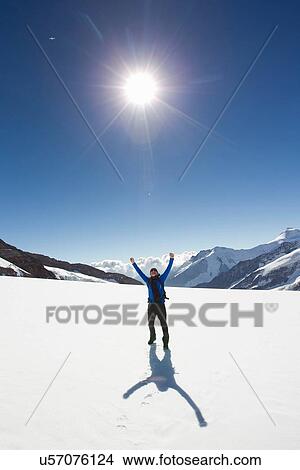 "Male hiker celebrating in snow covered landscape, Jungfrauchjoch, Grindelwald, Switzerland" View Large Photo Image Picture - "Male hiker celebrating in snow covered landscape, Jungfrauchjoch, Grindelwald, Switzerland". Fotosearch