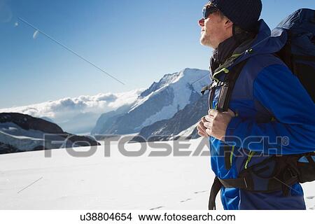 "Male hiker in snow covered mountain landscape, Jungfrauchjoch, Grindelwald, Switzerland" View Large Photo Image Picture - "Male hiker in snow covered mountain landscape, Jungfrauchjoch, Grindelwald, Switzerland". Fotosearch