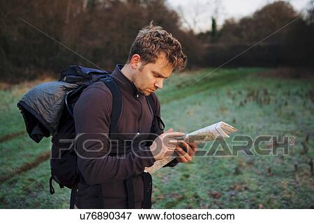 Male hiker reading map in field View Large Photo Image Stock Photo - Male hiker reading map in field. Fotosearch