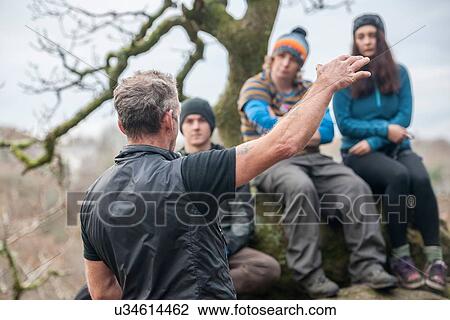 Male instructor talking to group of rock climbers View Large Photo Image Stock Image - Male instructor talking to group of rock climbers. Fotosearch