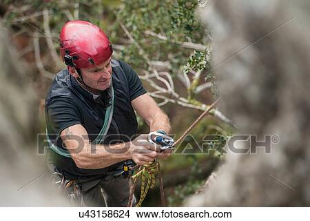 Male rock climber using carabiner View Large Photo Image Picture - Male rock climber using carabiner. Fotosearch
