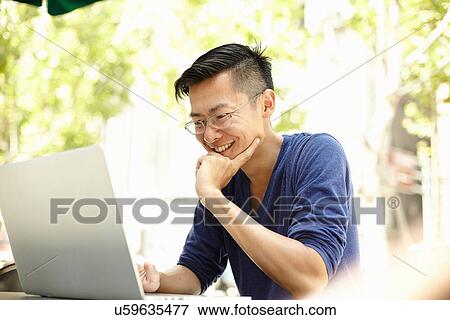 "Male tourist using laptop at sidewalk cafe, The Bund, Shanghai, China" View Large Photo Image Stock Photo - "Male tourist using laptop at sidewalk cafe, The Bund, Shanghai, China". Fotosearch