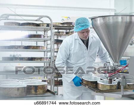 Male worker pouring cake mix in cake factory View Large Photo Image Picture - Male worker pouring cake mix in cake factory. Fotosearch