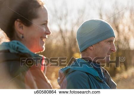"Man and woman in sunlight, looking away" View Large Photo Image Picture - "Man and woman in sunlight, looking away". Fotosearch