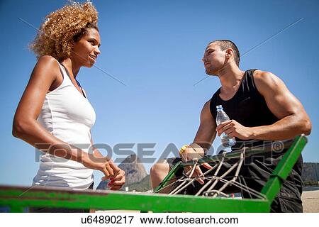 "Man and woman talking together, outdoors, low angle view" View Large Photo Image Stock Photo - "Man and woman talking together, outdoors, low angle view". Fotosearch