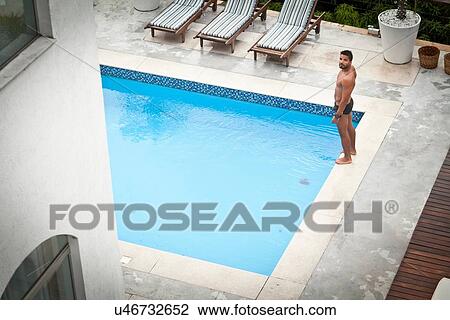 Man by poolside View Large Photo Image Stock Image - Man by poolside. Fotosearch