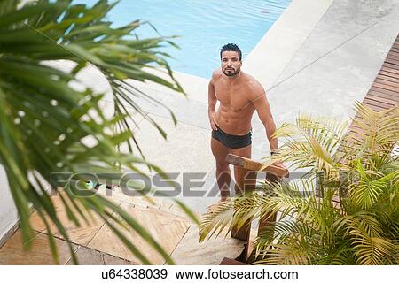 Man by poolside View Large Photo Image Stock Photo - Man by poolside. Fotosearch