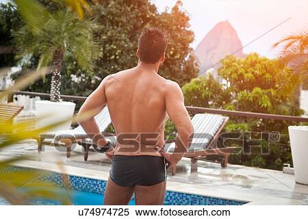 Stock Photography - "Man by poolside, Sugarloaf Mountain in background, RIo, Brazil". Fotosearch