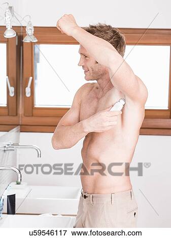 Man in bathroom applying roll on View Large Photo Image Stock Photo - Man in bathroom applying roll on. Fotosearch