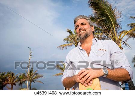 "Man, palm trees in background" View Large Photo Image Stock Photo - "Man, palm trees in background". Fotosearch
