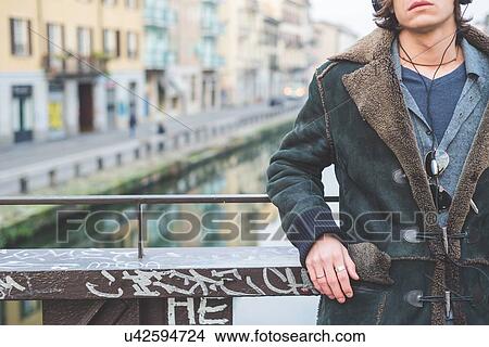 Picture - "Man standing by canal, Milan, Italy". Fotosearch