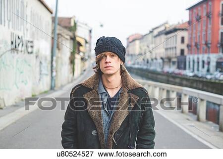 Stock Photo - "Man standing by canal, Milan, Italy". Fotosearch