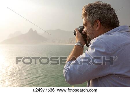 "Man taking photo of view, Ipanema Beach, Rio de Janeiro, Brazil" View Large Photo Image Stock Photograph - "Man taking photo of view, Ipanema Beach, Rio de Janeiro, Brazil". Fotosearch