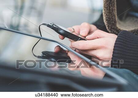 Stock Image - Man using digital tablet and smartphone. Fotosearch