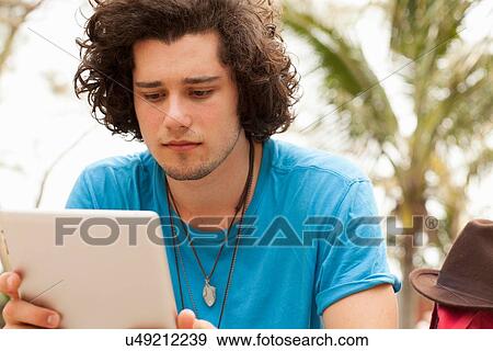 Stock Photo - Man using digital tablet. Fotosearch
