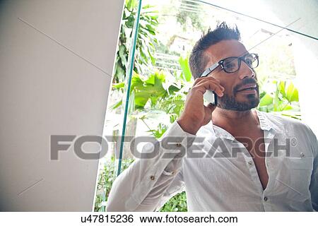 Man using phone View Large Photo Image Stock Photograph - Man using phone. Fotosearch