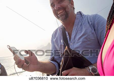 "Man using smartphone, Ipanema Beach, Rio de Janeiro, Brazil" View Large Photo Image Stock Image - "Man using smartphone, Ipanema Beach, Rio de Janeiro, Brazil". Fotosearch
