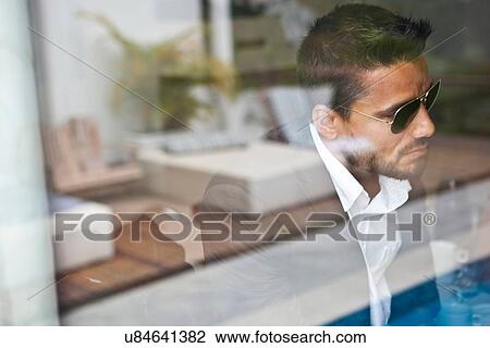 Stock Image - Man waiting indoors. Fotosearch