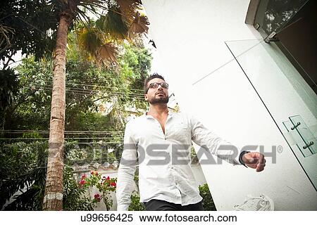 Man walking by door View Large Photo Image Stock Photography - Man walking by door. Fotosearch