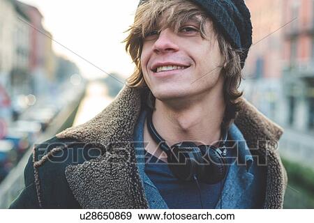 Man with headphones hung around neck View Large Photo Image Stock Photo - Man with headphones hung around neck. Fotosearch