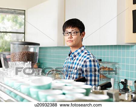 Man working behind coffee bar View Large Photo Image Stock Photo - Man working behind coffee bar. Fotosearch