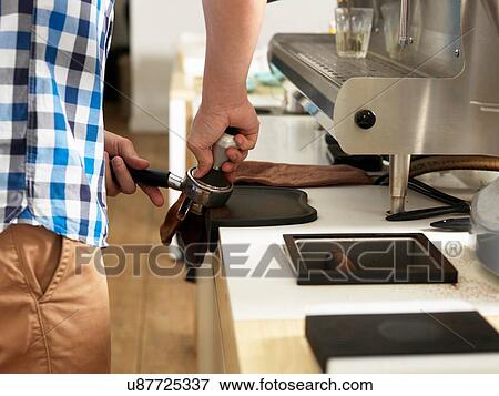 Man working behind coffee bar View Large Photo Image Stock Photo - Man working behind coffee bar. Fotosearch