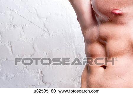 Stock Image - Man's torso showing abdominal muscles. Fotosearch
