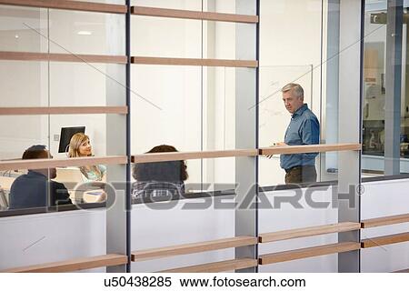 Mature businessman making presentation on office whiteboard View Large Photo Image Stock Photography - Mature businessman making presentation on office whiteboard. Fotosearch