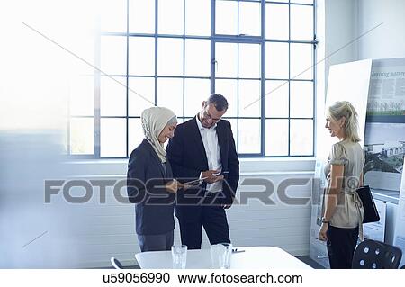 Mature businesswoman presenting ideas to team in office View Large Photo Image Stock Image - Mature businesswoman presenting ideas to team in office. Fotosearch