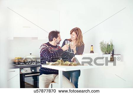 Mature couple toasting and preparing food in kitchen View Large Photo Image Stock Image - Mature couple toasting and preparing food in kitchen. Fotosearch