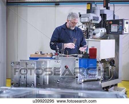Mature engineer using lathe in engineering factor View Large Photo Image Stock Photography - Mature engineer using lathe in engineering factor. Fotosearch