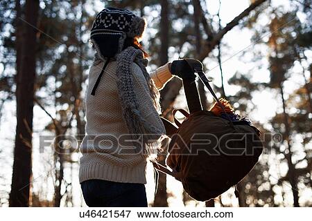 Mature female backpacker lifting up backpack in forest View Large Photo Image Stock Photo - Mature female backpacker lifting up backpack in forest. Fotosearch