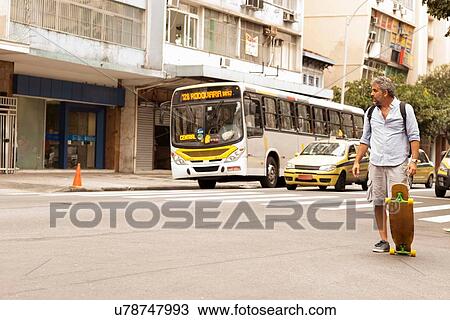 "Mature male skateboarder crossing road, Copacabana town, Rio De Janeiro, Brazil" View Large Photo Image Stock Image - "Mature male skateboarder crossing road, Copacabana town, Rio De Janeiro, Brazil". Fotosearch