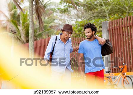 "Mature man and son strolling and chatting, Ipanema beach, Rio De Janeiro, Brazil" View Large Photo Image Stock Photo - "Mature man and son strolling and chatting, Ipanema beach, Rio De Janeiro, Brazil". Fotosearch