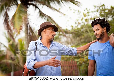 "Mature man chatting to son, Ipanema beach, Rio De Janeiro, Brazil" View Large Photo Image Stock Image - "Mature man chatting to son, Ipanema beach, Rio De Janeiro, Brazil". Fotosearch