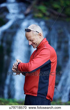 Mature man checking watch View Large Photo Image Stock Image - Mature man checking watch. Fotosearch