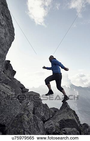 "Mature man jumping on rocks, Valais, Switzerland" View Large Photo Image Stock Photography - "Mature man jumping on rocks, Valais, Switzerland". Fotosearch