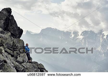 "Mature man leaning against rocks, Valais, Switzerland" View Large Photo Image Stock Photo - "Mature man leaning against rocks, Valais, Switzerland". Fotosearch