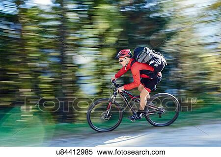 Stock Photography - Mature man mountain biking. Fotosearch