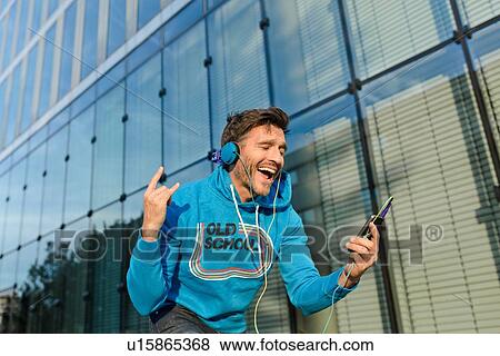Mature man on city street dancing to headphone music View Large Photo Image Stock Photo - Mature man on city street dancing to headphone music. Fotosearch