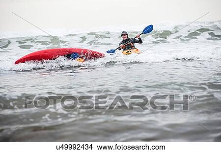 Mature man rescuing person fallen in sea in kayak View Large Photo Image Picture - Mature man rescuing person fallen in sea in kayak. Fotosearch