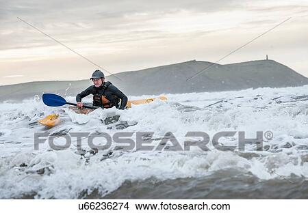 "Mature man sea kayaking, Polzeath, Cornwall, England" View Large Photo Image Picture - "Mature man sea kayaking, Polzeath, Cornwall, England". Fotosearch