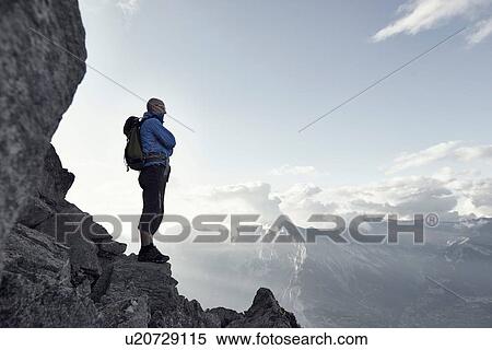 "Mature man standing on rocks, Valais, Switzerland" View Large Photo Image Stock Photography - "Mature man standing on rocks, Valais, Switzerland". Fotosearch
