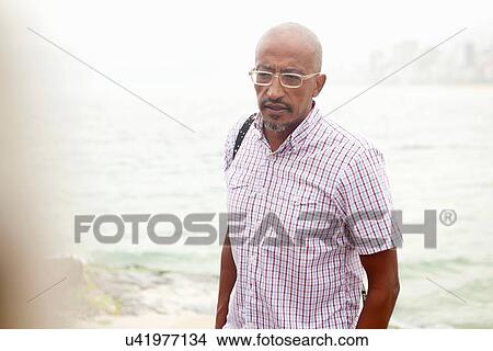 "Mature man strolling on Ipanema beach, Rio De Janeiro, Brazil" View Large Photo Image Picture - "Mature man strolling on Ipanema beach, Rio De Janeiro, Brazil". Fotosearch