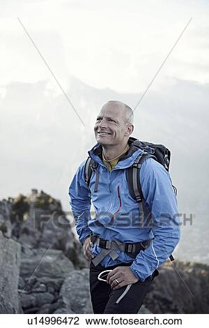 Stock Image - "Mature man wearing blue jacket, portrait". Fotosearch