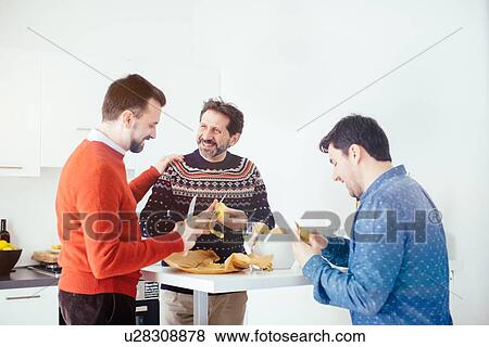Men enjoying champagne while peeling potatoes in kitchen View Large Photo Image Stock Photo - Men enjoying champagne while peeling potatoes in kitchen. Fotosearch