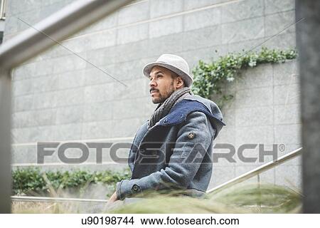Mid adult businessman looking away from wall View Large Photo Image Picture - Mid adult businessman looking away from wall. Fotosearch